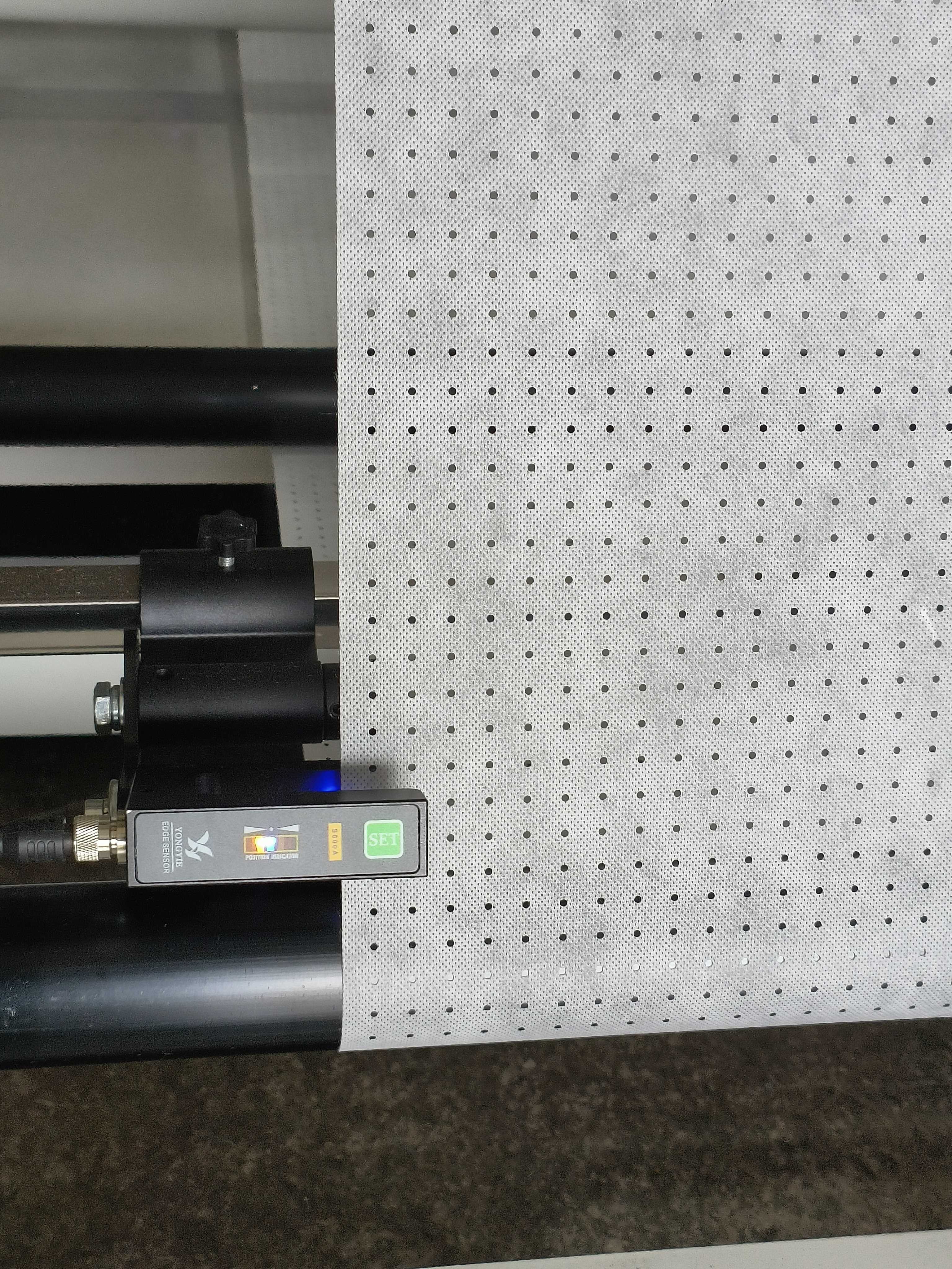 Perforated material moving through a Lanqun machine